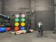 TechRadar fitness writer Harry Bullmore lying down next to a rowing machine after finishing a 2K row